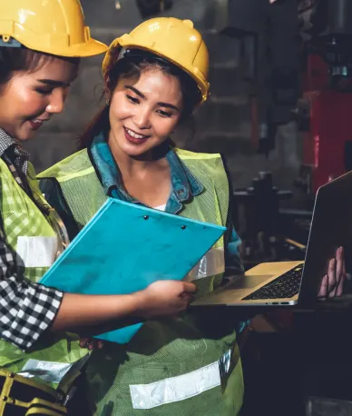 Factory job workers working and discussing manufacturing plan in the factory .